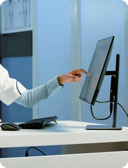 A practitioner reviewing the Doctena Pro dashboard alongside their existing practice software.