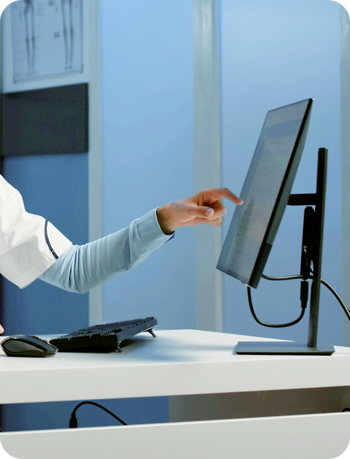 A practitioner reviewing the Doctena Pro dashboard alongside their existing practice software.